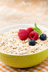 Oatmeal porridge with berries. Raspberries and blueberries.