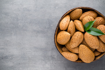 Group of almond nuts with leaves.Wooden background.