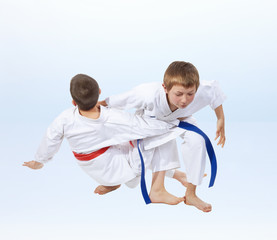 On a light background doing throws of judo athletes
