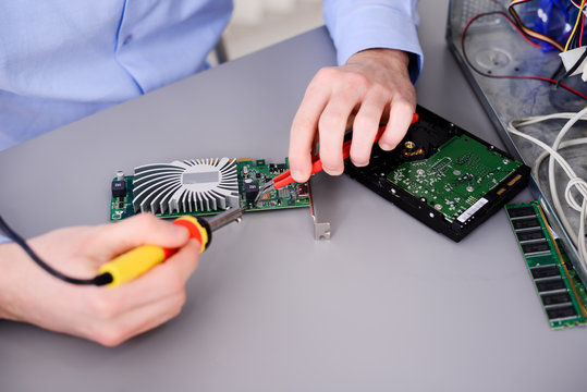 Handsome Young Computer Technician Repairing Desktop Computer