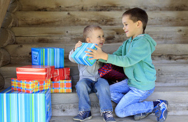 children look forward to unwrapping gifts. two boys with lots of gifts