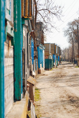 Street in the village with wooden houses along the road