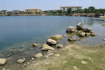 rocky pond with the building on the distance bank
