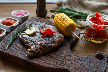 Delicious beef steak on wooden table, close-up