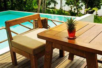 chair and the table near the pool