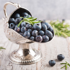 Fresh blueberries in vintage metal sugar bowl