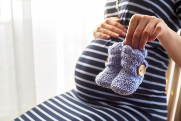 Pregnant woman little baby boots