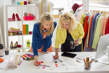 Two creative fashion designers looking at sketch