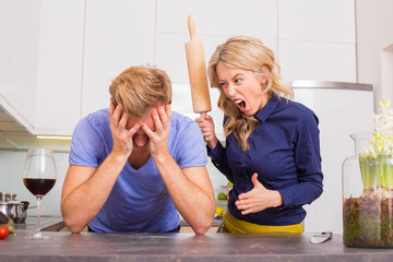 Woman in kitchen being angry at her man