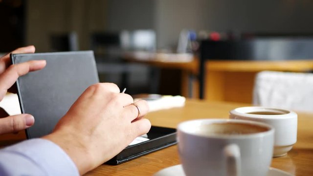 Male hand paying bill in cafe with creadit card