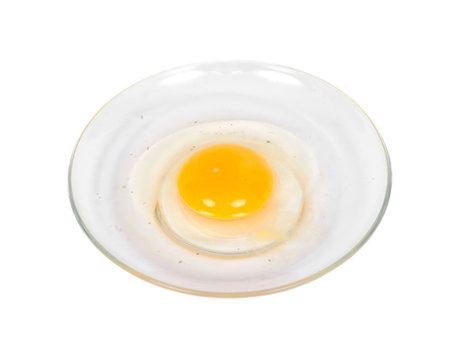 Cracked egg on plate separated on white background