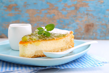 cheesecake with kiwi on a plate decorated with mint