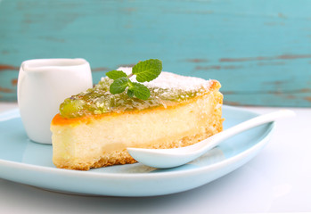 cheesecake with kiwi on a plate decorated with mint