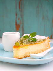 cheesecake with kiwi on a plate decorated with mint