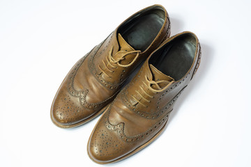 brown used budapester shoes on white background
