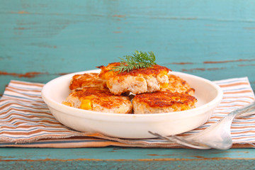 cutlets from poultry with grains of corn