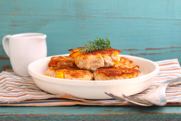 cutlets from poultry with grains of corn