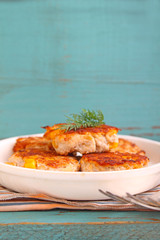 cutlets from poultry with grains of corn
