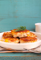 cutlets from poultry with grains of corn