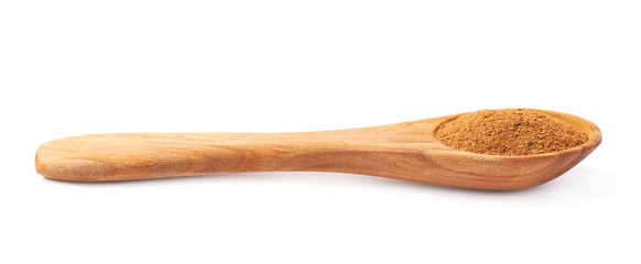 Wooden spoon full of cinnamon