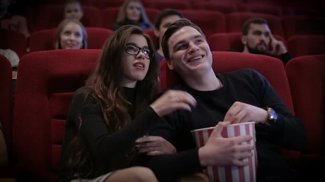 Couple waching a movie at cinema