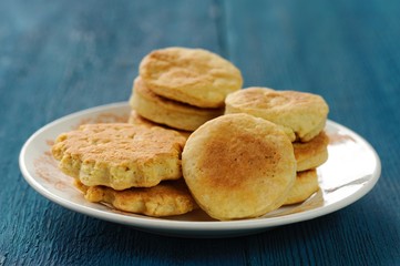 Plate of tasty imperfect homemade cookies on deep blue backgroun