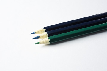 green and blue colored pencils isolated on white background