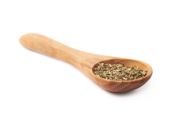Wooden spoon and dried basil