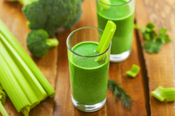 Healthy green smoothie on table, celery and broccoli juice mix