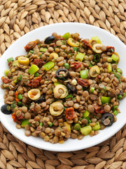 Lentil salad with green peppers, dried tomatoes and olives