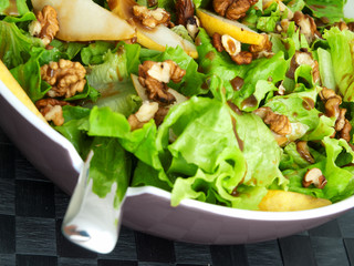 Iceberg salad with walnuts and pears, close up