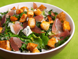 French Provencal Salad with green salad, bacon, croutons and blue cheese. Close up, horizontal shot