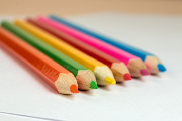 colored pencils to draw lying on a blank sheet of paper