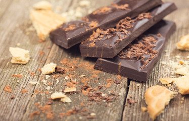 Pieces of chocolate and cookies crumbs on old boards