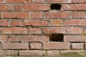 Old brick wall with some holes