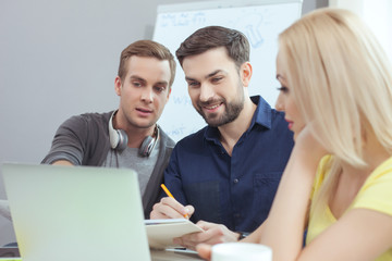 Obraz premium Skillful three workers are working in office
