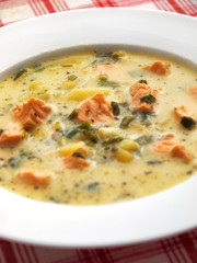 Healthy fish soup with salmon, celery, potatoes and sour cream