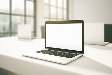 Blank laptop in office side