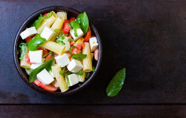 Italian food. Vegetarian salad with pasta, vegetables and cheese.Top view