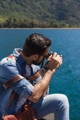 Young man taking a picture of a lake at Patagonia Argentina.