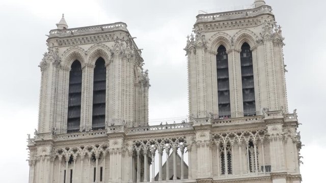 World wide recognizable Notre-Dame Cathedral located in France capital Paris 4K 2160p UltraHD tilt footage - Famous Notre Dame de Paris church by the day 4K 3840X2160 UHD tilting video 