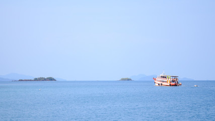 ship on blue sea and green island