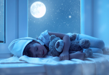child little girl sleeping at window dreaming and admiring the s