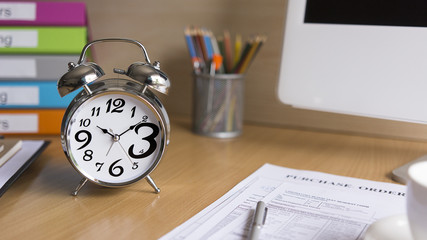 Alarm clock on wooden office desk