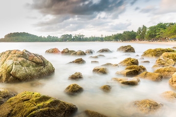 rock beach in the morning with long exposure photography