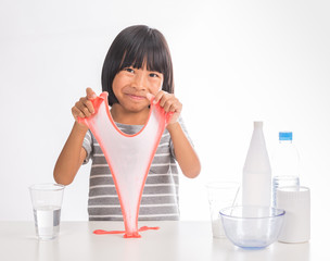 cute little asian girl making science experiment of slime on isolate white background