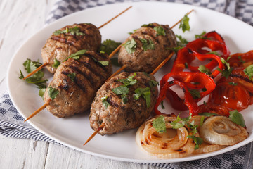 Kefte kebab with grilled vegetables on a plate close-up. horizontal
