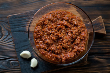 Above view of bolognese sauce in a glass bowl, close-up