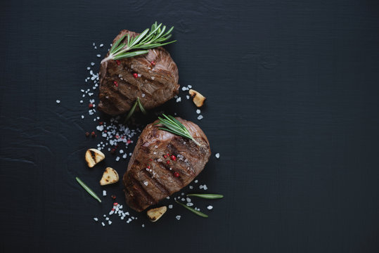 Top View Of Grilled Filet Mignon Steaks, Black Wooden Surface