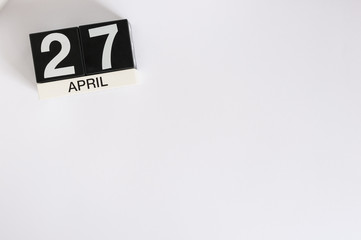 April 27th. Image of april 27 wooden color calendar on white background.  Spring day, empty space for text